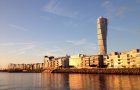 The apartments and Turning Torso sky scraper in Vastra Hamnen Western Harbour at a golden sunset in Malmo Sweden.